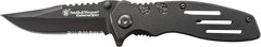Smith & Wesson Extreme Ops blade close-up shows serrated clip point for tough tasks.