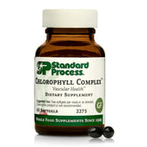 Standard Process Chlorophyll Complex bottle on countertop signaling detox support.
