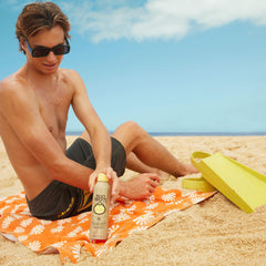 Sun Bum Original SPF 70 spray on skin close-up showing lightweight texture.