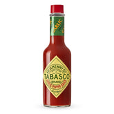 TABASCO Cayenne Garlic Pepper Sauce bottle on counter adds mild heat to meals.