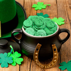 Taboom milk chocolate coins in green foil close-up showing creamy texture.
