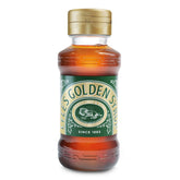 Lyle's Golden Syrup bottle being poured, perfect for rich desserts and baking.