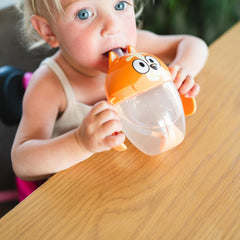 The First Years Bingo weighted straw cup with easy-grip handles aids toddler learning.