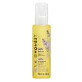 The Honest Company lavender-infused body oil bottle shown for soothing, hydrating baby skin.