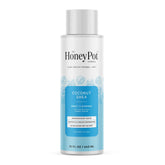 The Honey Pot Coconut Shea Hydrating body cleanser bottle being poured for gentle cleansing