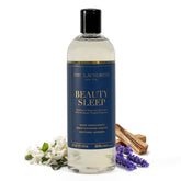 The Laundress Beauty Sleep detergent bottle pours to freshen bedding with a calming lavender-sandalwood scent.