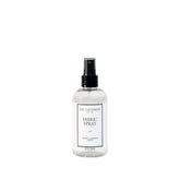 The Laundress Isle fabric spray bottle refreshing fabrics with a coastal scent.