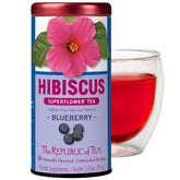 The Republic of Tea Hibiscus Blueberry Superflower tea bag tin front view, premium caffeine-free refreshment.