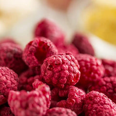 The Snack Haus raspberries granola bowl accent adds color and crunch