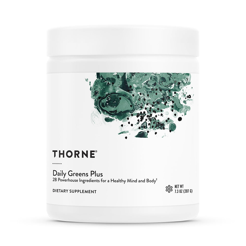 THORNE Daily Greens Plus mint powder in a glass for refreshing daily nutrition