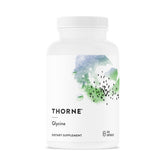 THORNE Glycine relaxation capsules on shelf, supporting calm and balanced stress management.