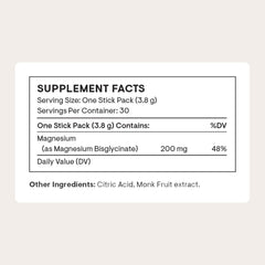 THORNE Magnesium Bisglycinate powder scoop shown beside a glass, ideal for easy mixing.