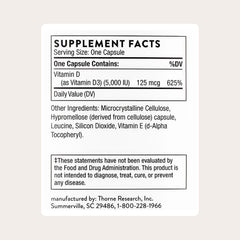 THORNE Vitamin D-5,000 capsules inside bottle; convenient for daily muscle and bone health.