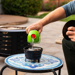 TIKI Mini Pit Table Torch with durable metal frame enhances yard lighting.