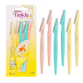 Tinkle Dermaplaning Tool razor in hand for precise brow shaping.