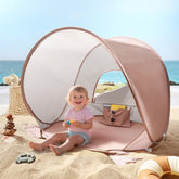 Tiny Land baby beach tent pops up for quick shade and UV protection.