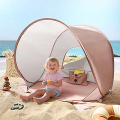 Tiny Land baby beach tent pops up for quick shade and UV protection.