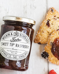 Tiptree Raspberry Preserve jar in a pantry, showing natural ingredients.