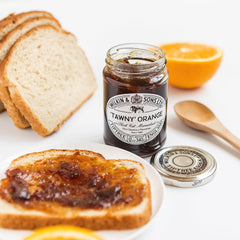 Tiptree Tawny Marmalade jar close-up with spoonful of glossy marmalade.