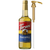 Torani Pineapple Syrup bottle with pump for precise tropical flavoring in drinks.