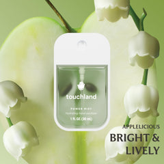 Touchland Blossom Velvet Peach spray shows vibrant color and hydrating mist.
