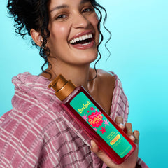 Tree Hut Raspberry Fizz bottle with rose petals scent in focus for mood