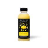 Twisted Alchemy lemon juice bottle pour shows fresh citrus for vibrant cocktails.