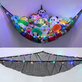 Unicorn Castle stuffed animals hammock with LED light in black, ideal for cozy playroom organization.