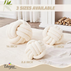 Uvvyui knot-ball pillow closeup shows plush lamb-wool texture and soft touch.