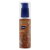 Vaseline Illuminate Me Shimmering Body Oil bottle pour showing copper shimmer for melanin-rich skin