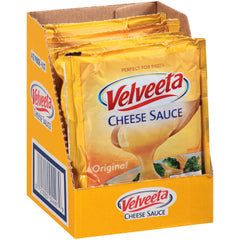 Velveeta Original Cheese Sauce Pouches over nachos for creamy topping.