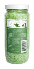 Pouring Village Naturals Therapy soak into warm water for a rejuvenating bath.