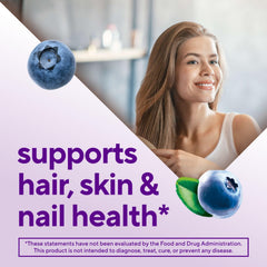 Vitafusion Biotin gummies in hand, easy daily supplement.