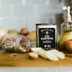 Open Watkins pepper tin showing fresh ground pepper for quick seasoning.