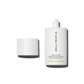 Well People Daygleamer bottle closeup showing mineral sunscreen serum for radiant, protected skin.