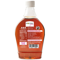 Wholesome Yum Zero Sugar Maple Syrup on a stack of pancakes with drizzle.
