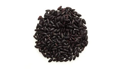 Raw dark grains of Yupik black rice before simmering in a pot.
