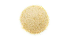 Yupik date powder jar on kitchen counter; versatile topping for yogurt and oats.