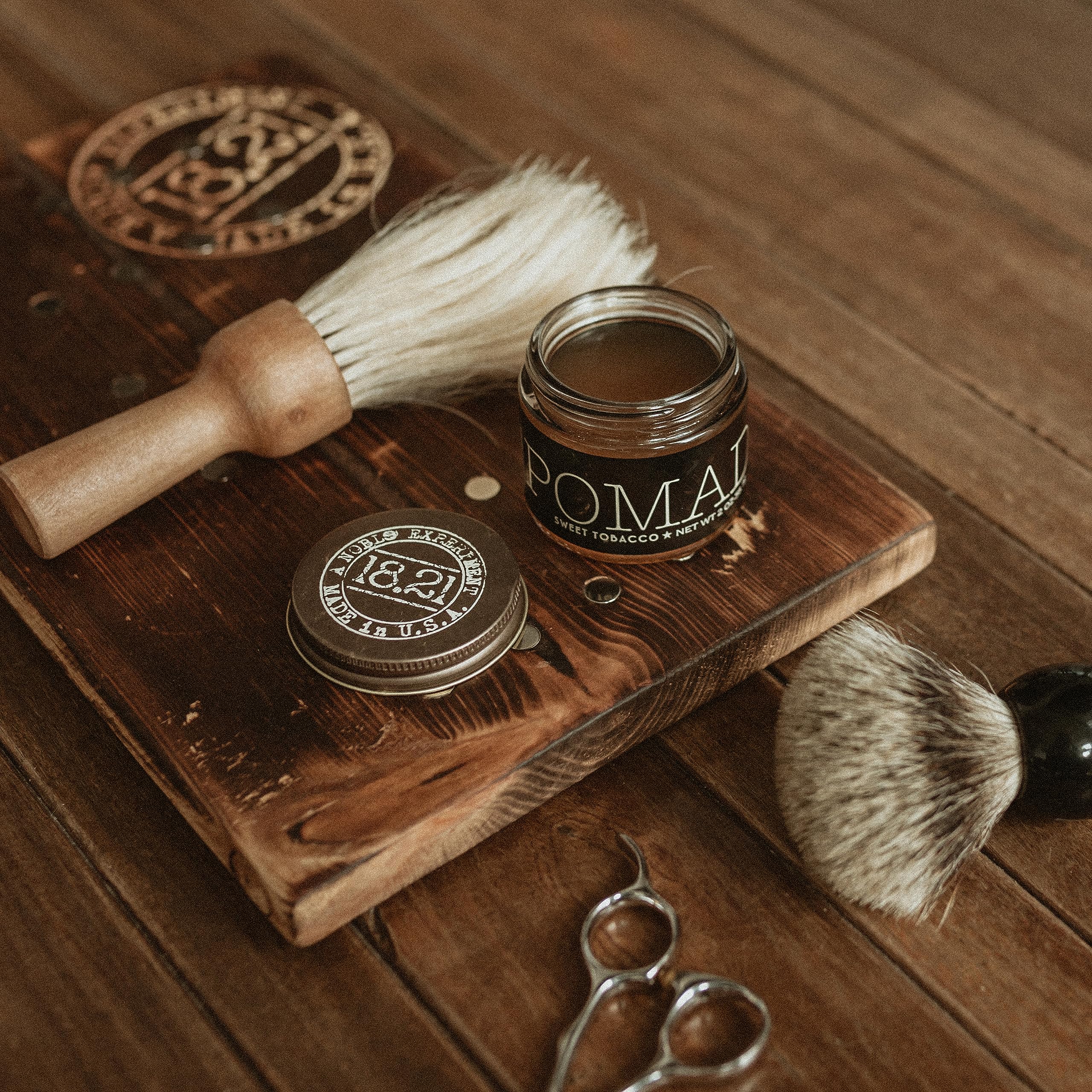 Short to medium hair styled with 18.21 Man Made pomade for smooth texture.