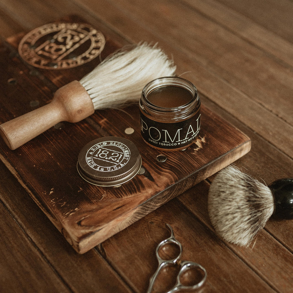 Short to medium hair styled with 18.21 Man Made pomade for smooth texture.