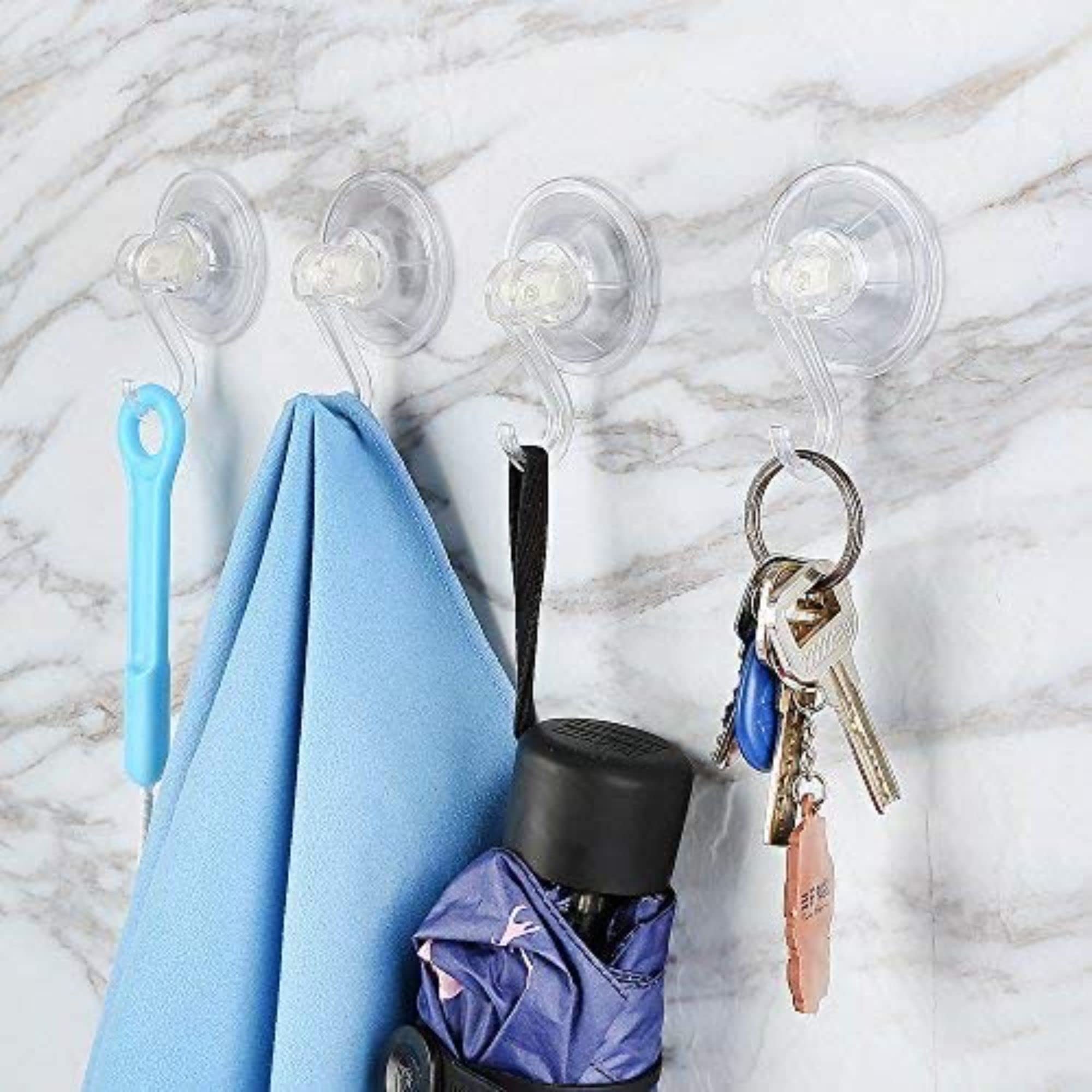 Users cleaning the suction cup before reapplication on a bathroom wall