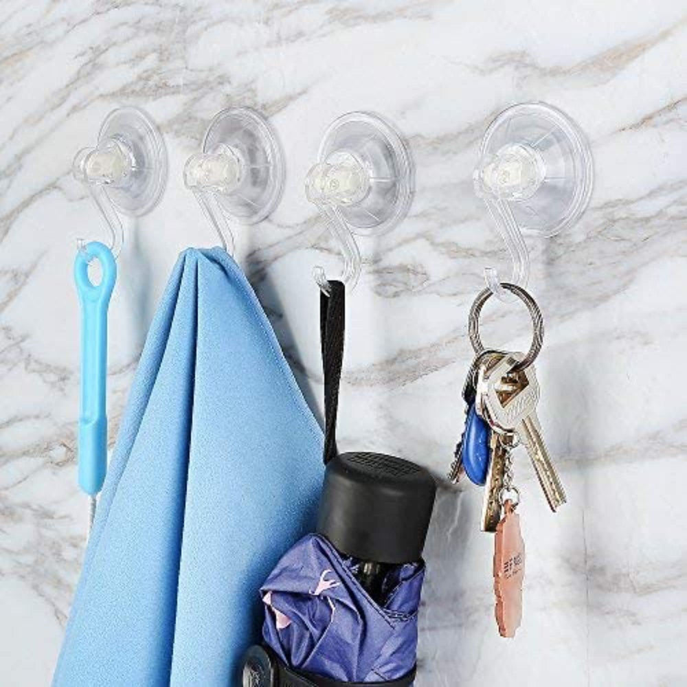 Users cleaning the suction cup before reapplication on a bathroom wall