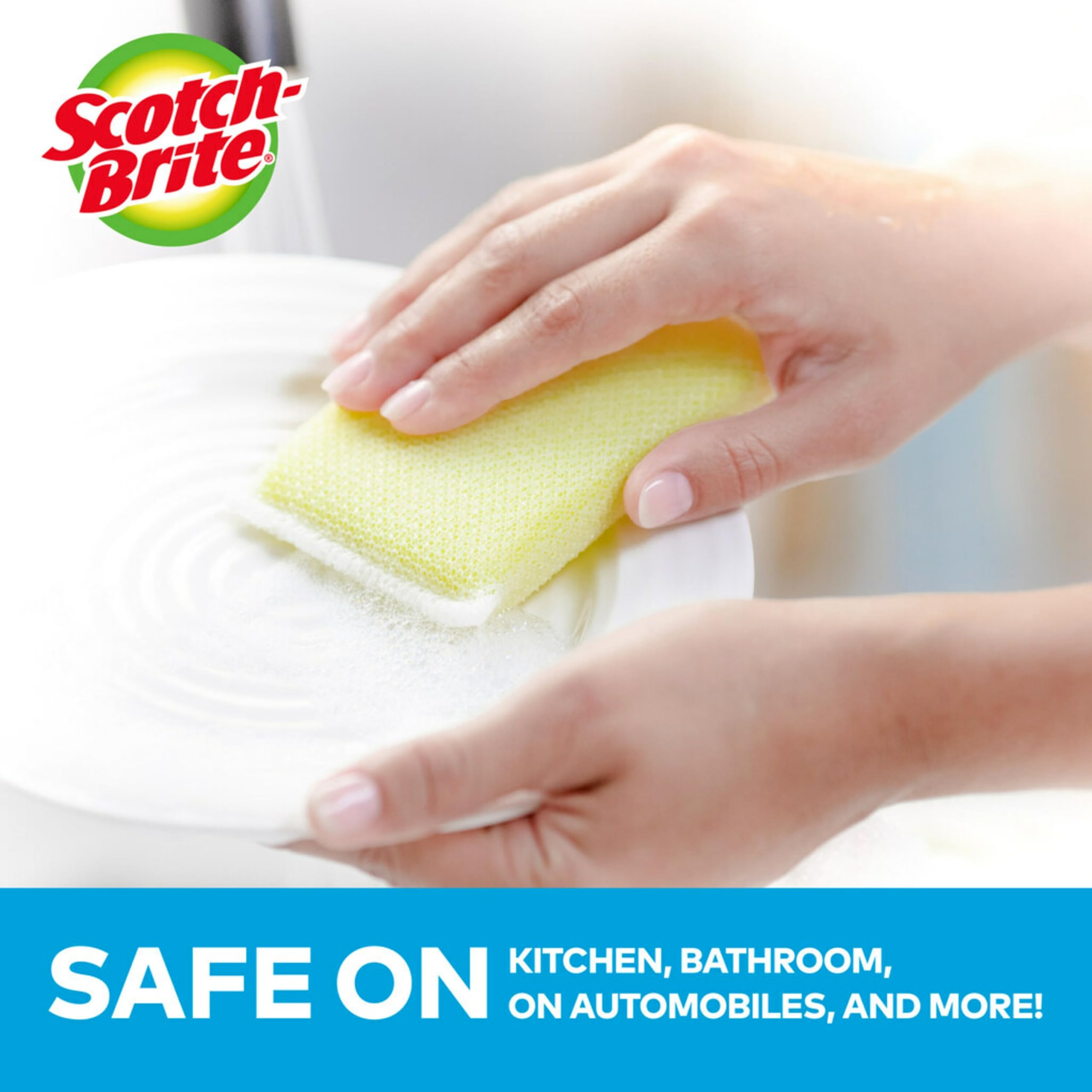 Dishes in a sink showing gentle scrubbing with safe 3M Scotch-Brite Dobie pads.