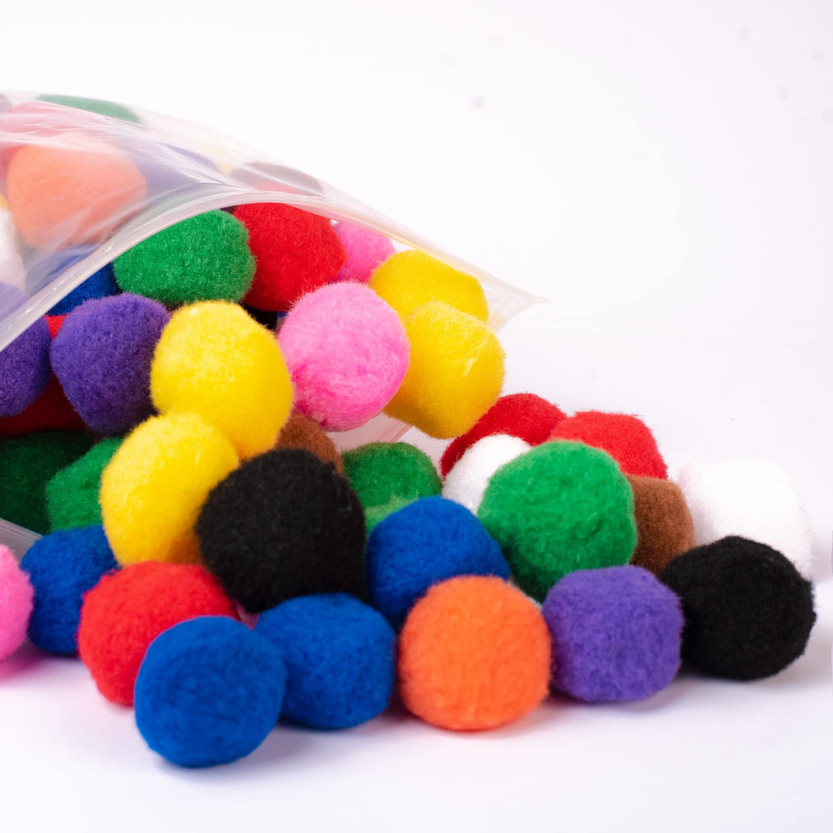 Adeweave 1.5-inch multicolor pom poms in a box for easy storage.