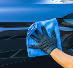 Aero Cosmetics car detailing in action image highlights waterless wash convenience anywhere.