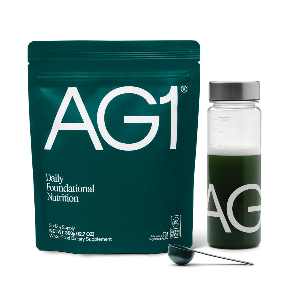 AG1 bottle with shaker on counter for convenient daily nutrition.