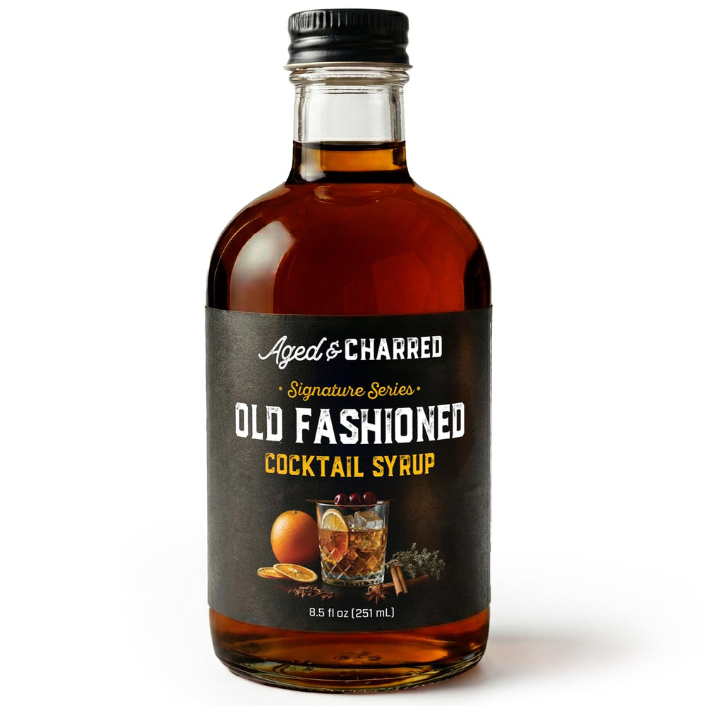 Aged & Charred Old Fashioned mix bottle being poured for a refined cocktail