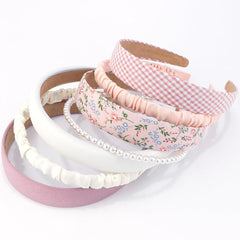 AHONEY pink headband with knotted design for secure all-day wear.