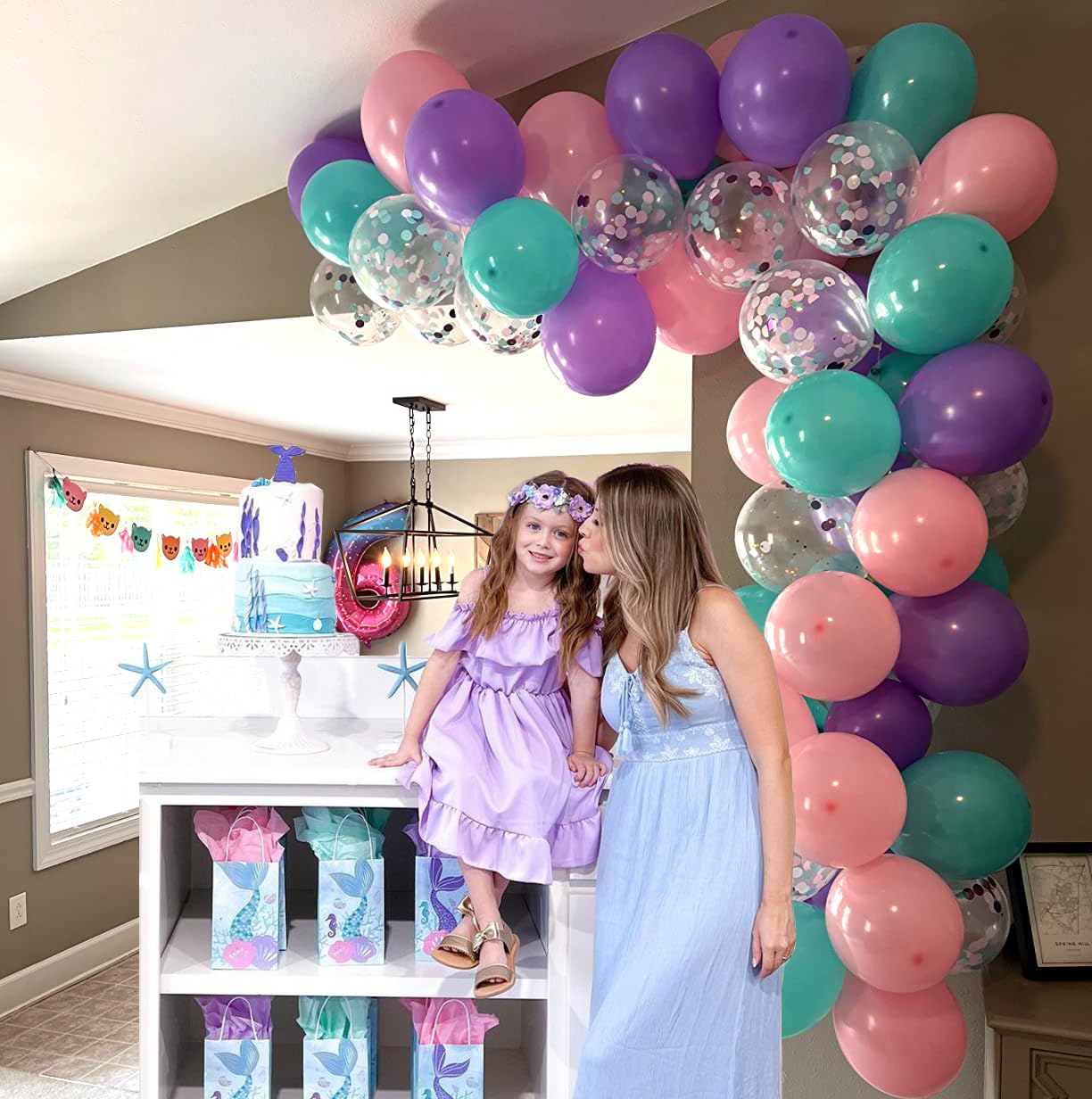 Aiwolf party setup using pink purple and teal balloons for a cohesive look.