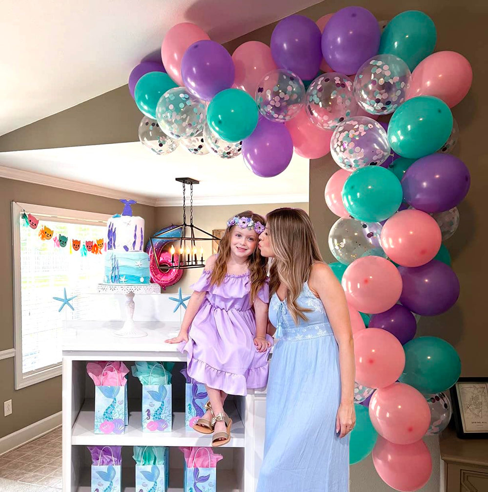 Aiwolf party setup using pink purple and teal balloons for a cohesive look.